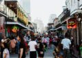 people walking on bourbon street in new orleans usa