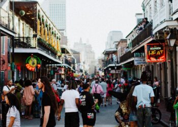 people walking on bourbon street in new orleans usa