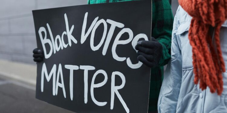 a person holding a political poster